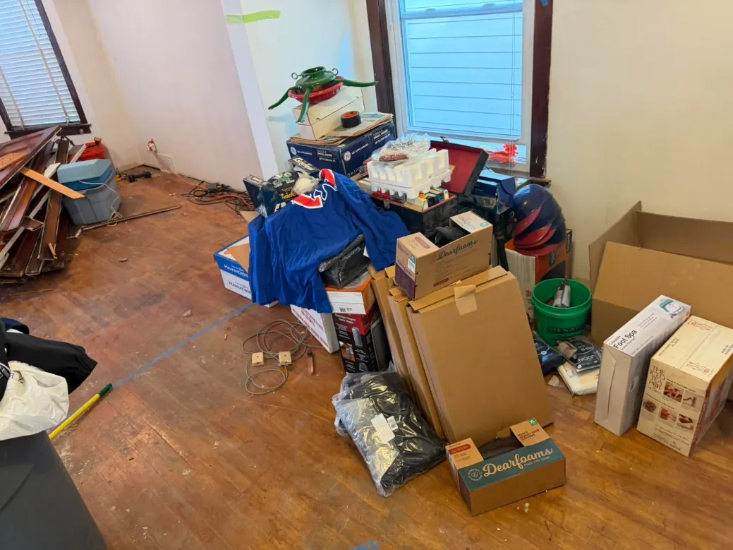 Spare room filled with boxes, bags and old belongings